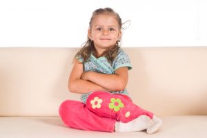 Child sitting legs to side